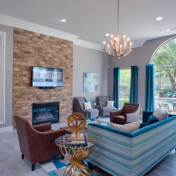 Clubhouse with Flatscreen TV, 3 Big Windows fireplace, and lots of artifacts on the shelfs