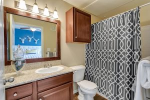 Bath with good lighting and cabinet above the toilet