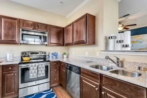 Kitchen with stainless steel appliances, granite counters, and hardwood style floors