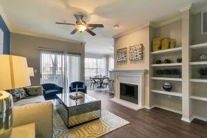 Living Room with Fireplace, built in shelving, and patio access