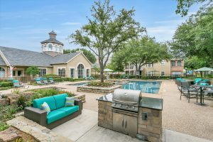 Pool Cooking Area with Modern Love Seats to lounge at whilst cooking on the gas grill