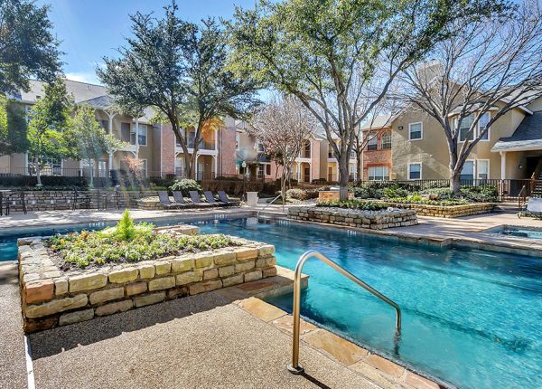 Apartment pool with landscaping and tree