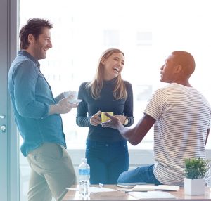 Diverse and casual coworker group laughs together