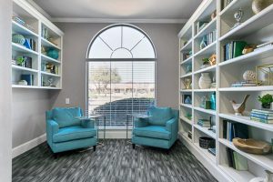 Public area with 2 plush chairs and laptop tables