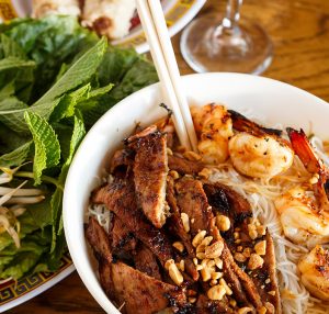 Closeup of vietnamese noodle bowl with meat and basil