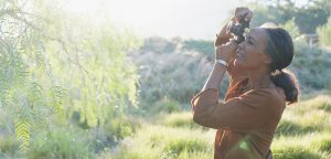 Older woman takes pictures of nature