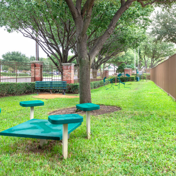 Bark Park area with Benches, obstacle courses, and nice tree coverage