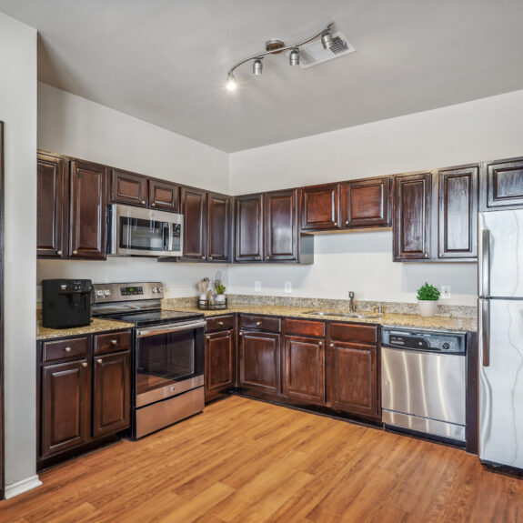 Open kitchen with granite counter tops and stainless steel appliances