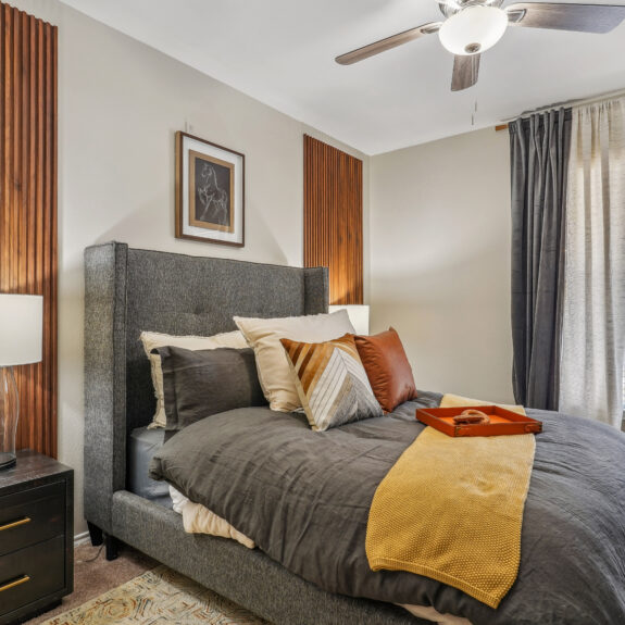 Bedroom with large windows and ceiling fan