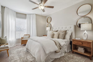 Bedroom with ceiling fan and large window